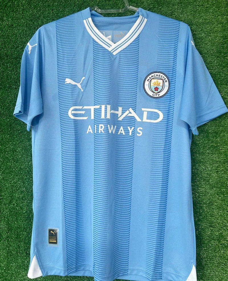 Camisola Manchester City I com PATCH 23/24 - Azul e Branca